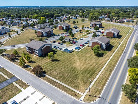 A suburban neighborhood with houses and a road.