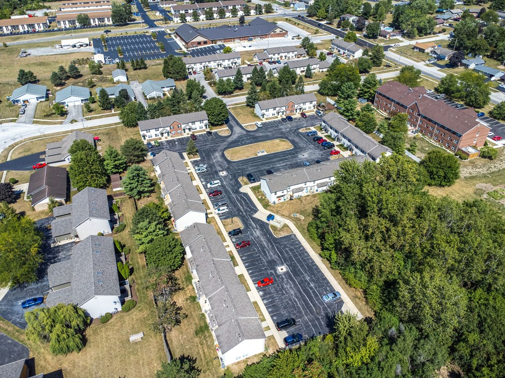 A bird's eye view of a residential area with a large parking lot.