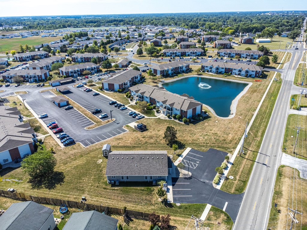 A bird's eye view of a residential area with a swimming pool and apartment buildings.