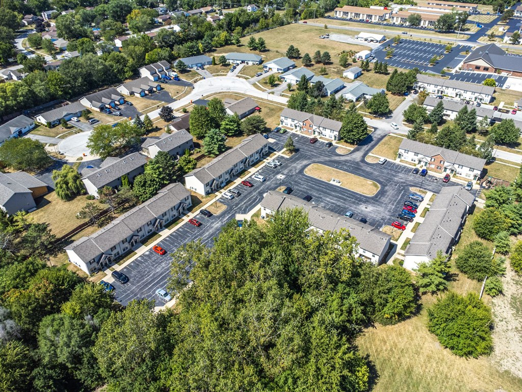 A large building with a parking lot in front of it.