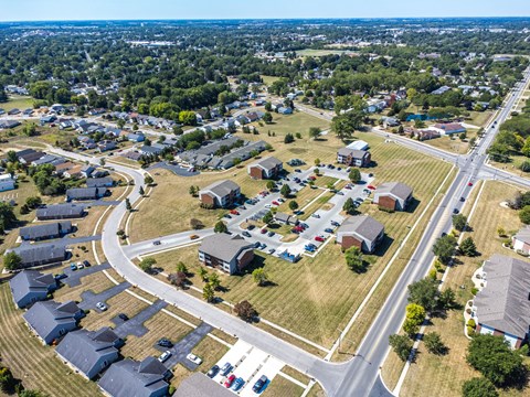A suburban neighborhood with houses and a road.