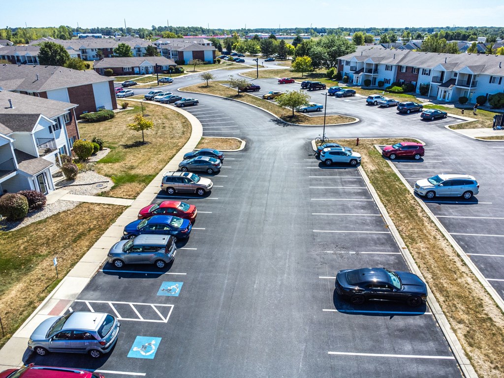 A parking lot with cars parked in designated spots.