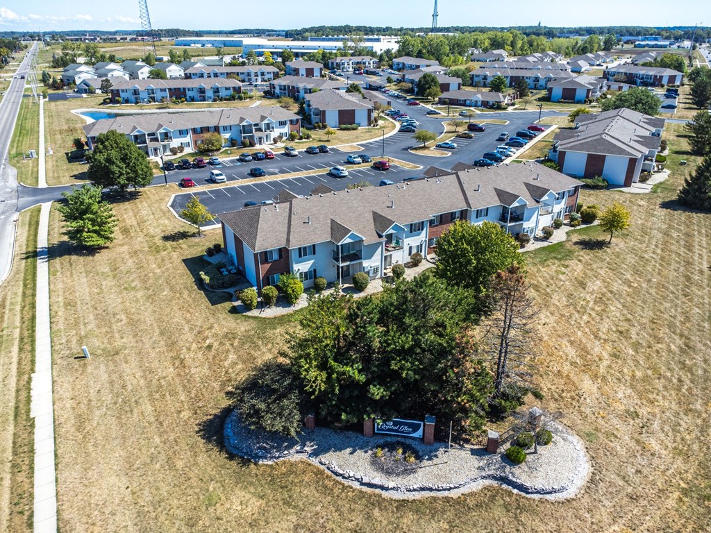 A bird's eye view of a residential area with houses and a sign in the foreground.