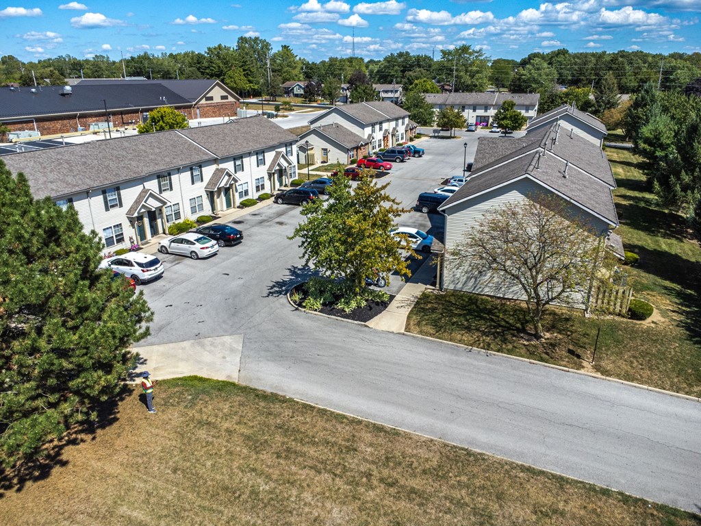 A large building complex with a parking lot in front.