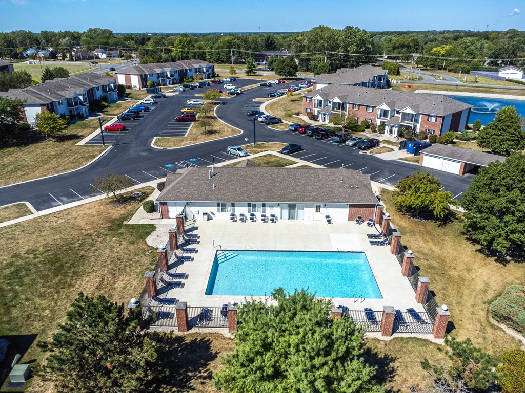 A bird's eye view of a residential complex with a swimming pool.