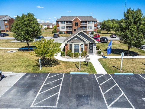 A parking lot with a building in the background.