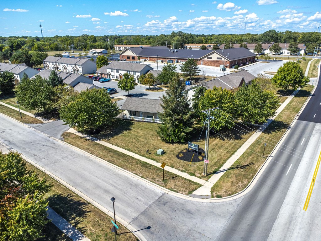 A suburban road with a parked car and a street light.