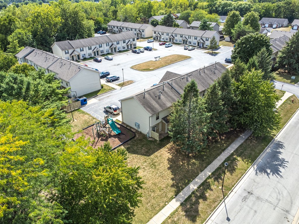 A bird's eye view of a residential area with houses and trees.