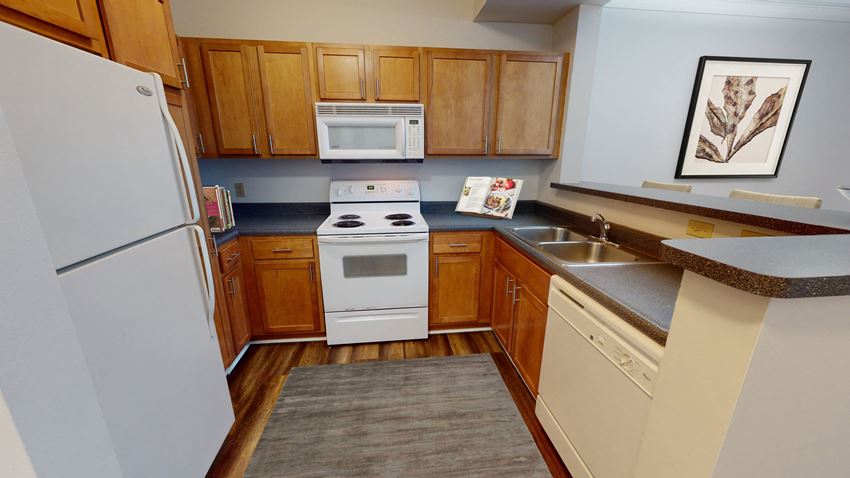 a kitchen with a white refrigerator freezer next to a white stove top oven - Photo Gallery