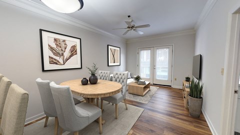 a living room with a table and chairs and a ceiling fan