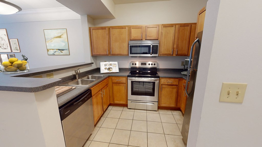 a kitchen with wooden cabinets and stainless steel appliances