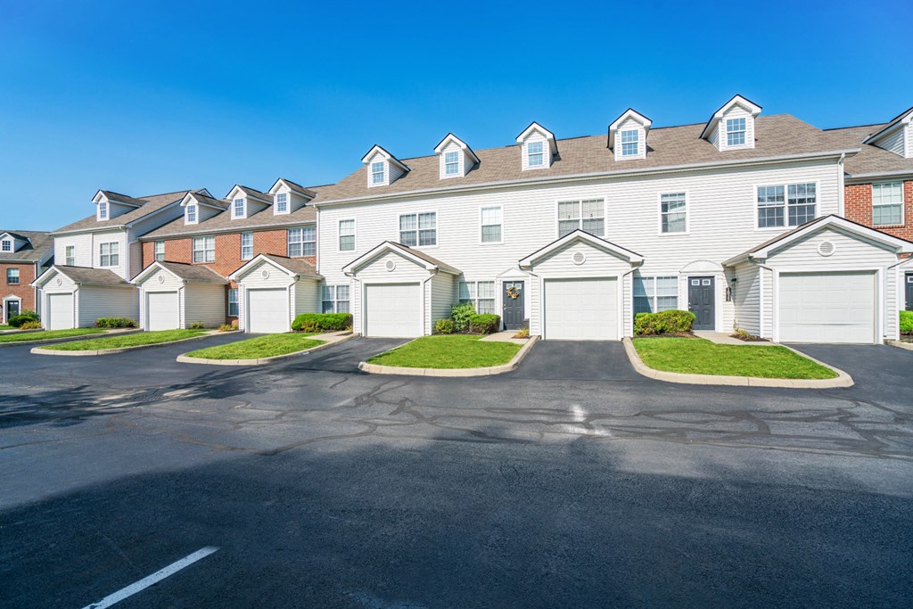 a row of houses with white doors on a street