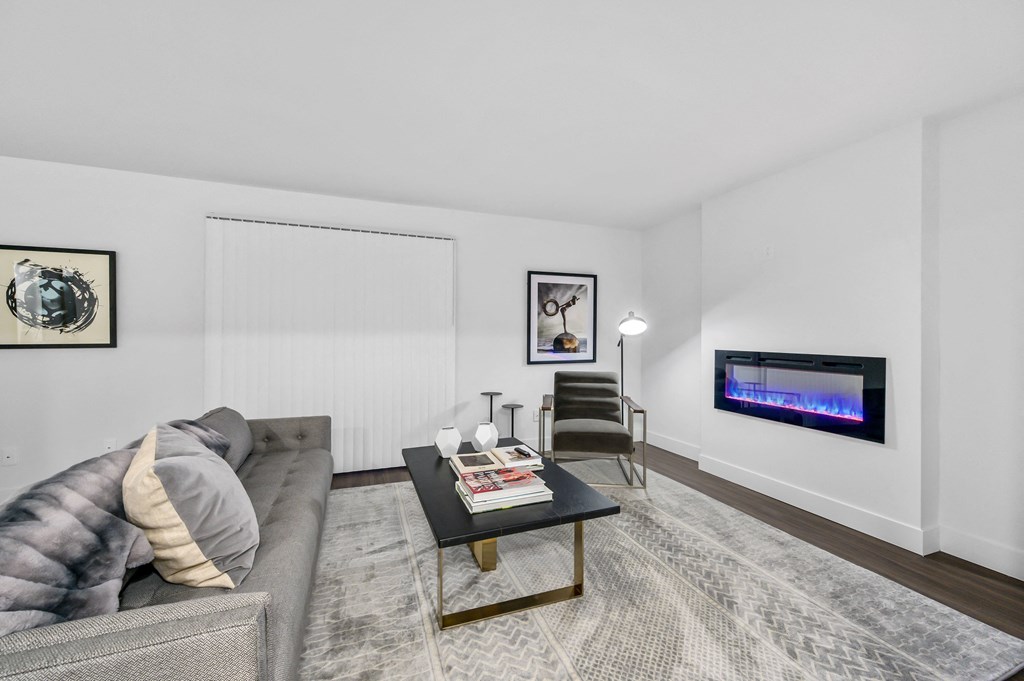 a living room with a couch coffee table and a fireplace