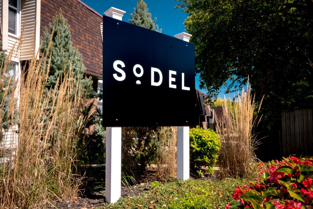 a sign in front of a house that says sold