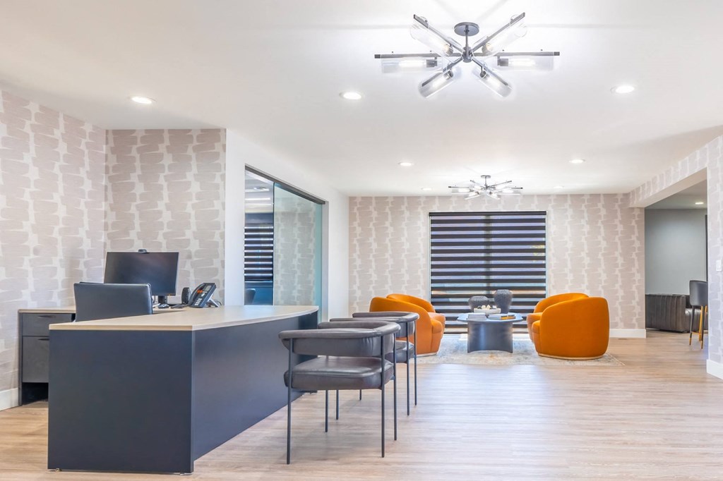 an office with a desk and chairs and a conference room