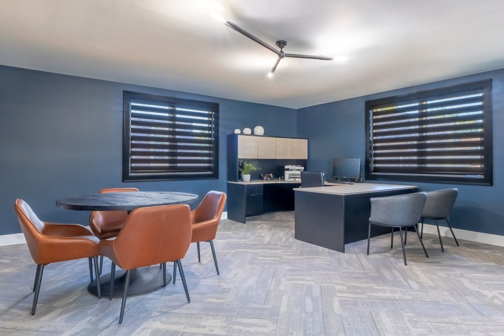a dining room with blue walls and a table and chairs