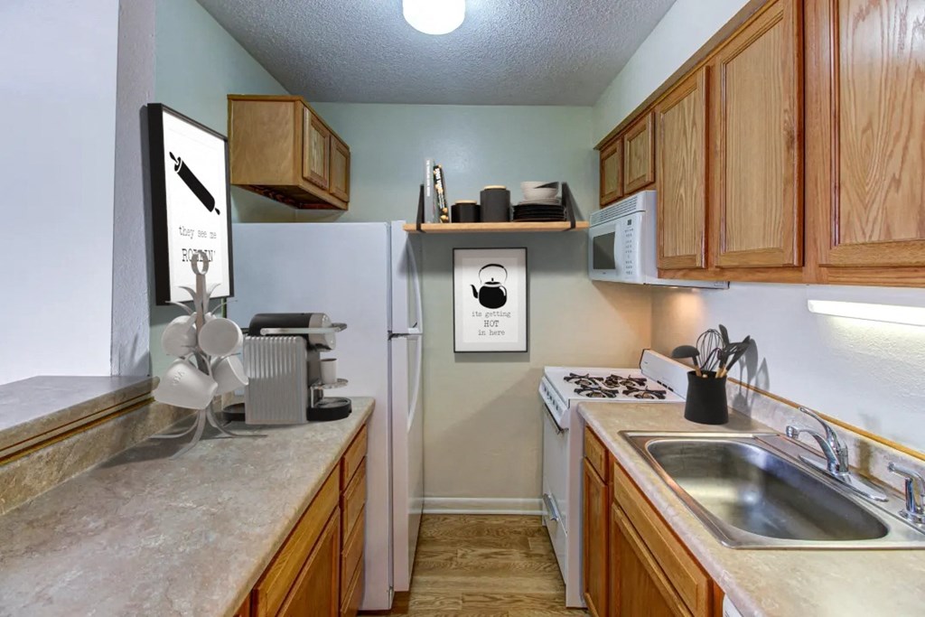 a kitchen with wood cabinets and white appliances