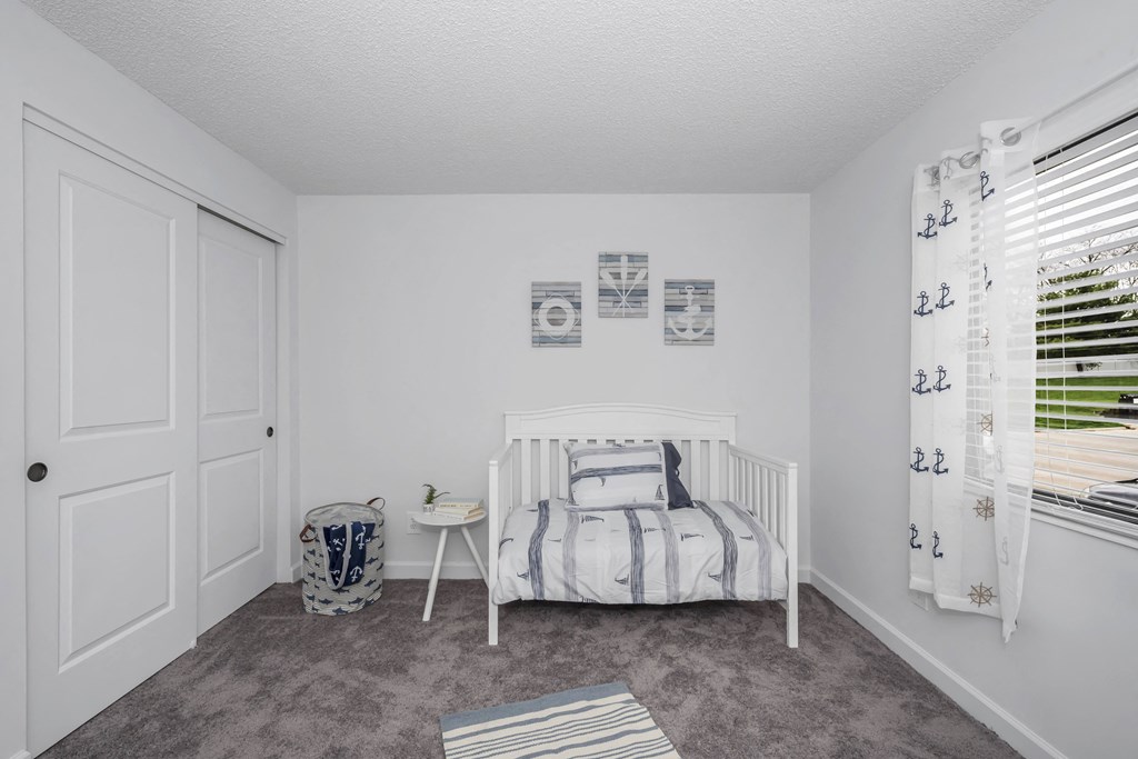 White bedroom with a white crib and a window at Tall Timber Apartments, Cincinnati, OH, 45241