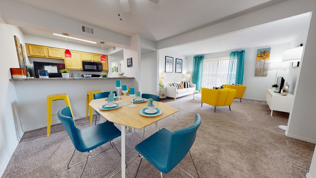 a dining room and living room with a table and chairs