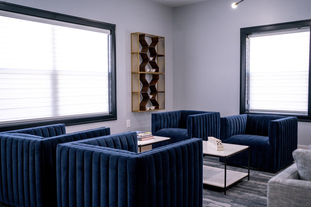 a living room with blue couches and a coffee table