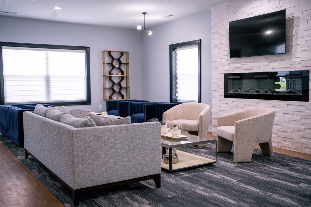 a living room with a couch and chairs and a television