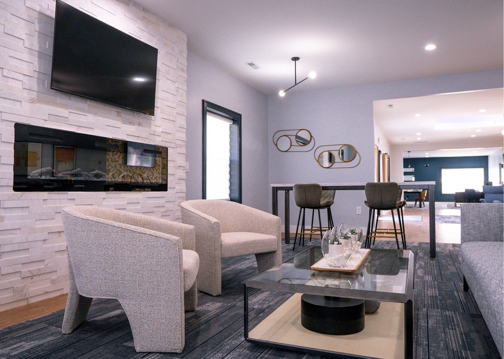 a living room with a fireplace and a table with chairs