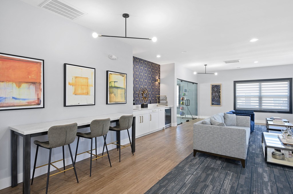 a living room with a kitchen and a dining table