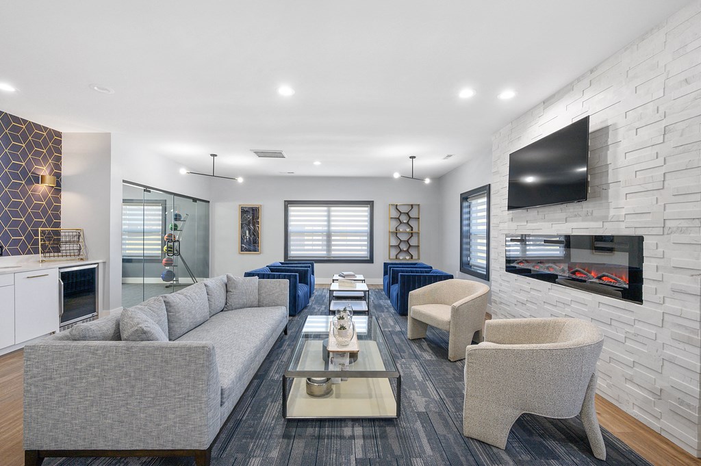 a living room with couches and chairs and a television