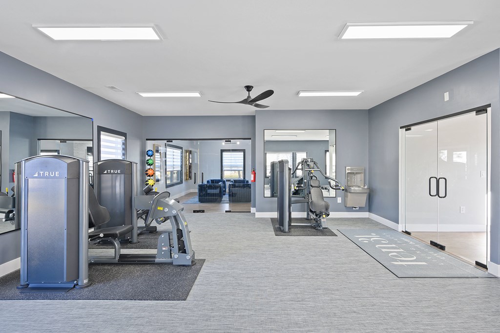 a gym with cardio machines and other exercise equipment in a building