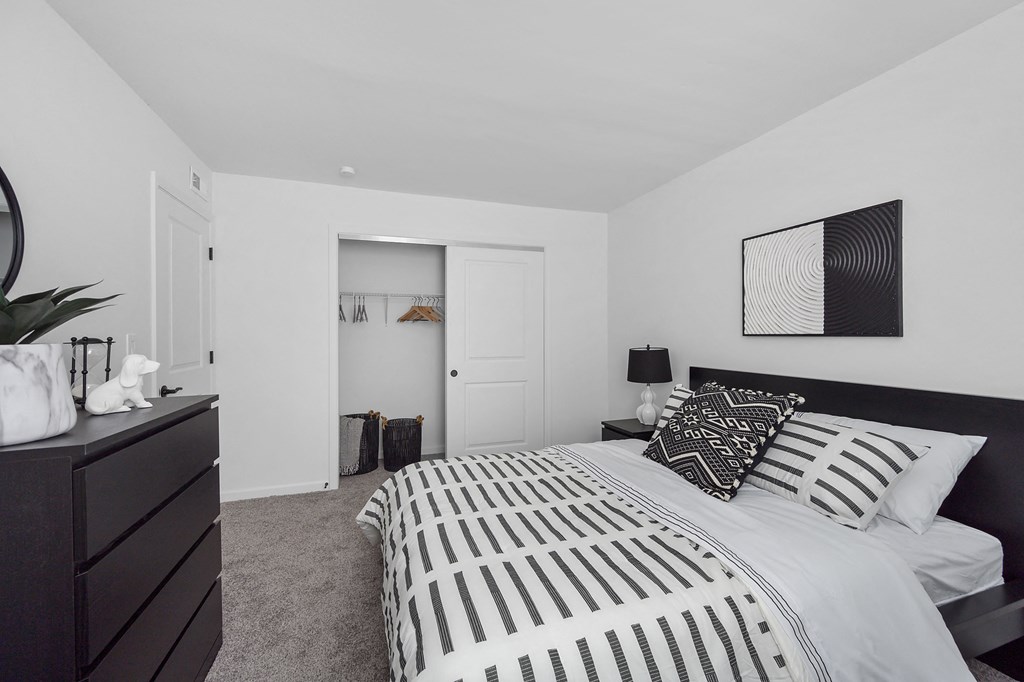 a bedroom with a large bed and a dresser