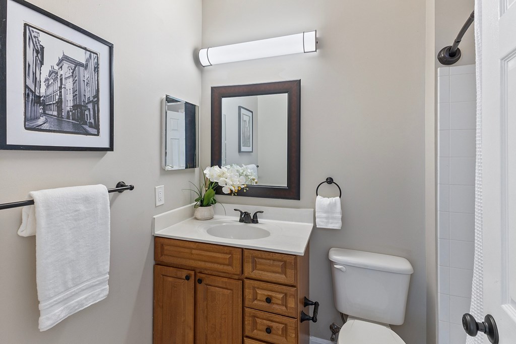 A bathroom with a towel hanging on a towel rack.