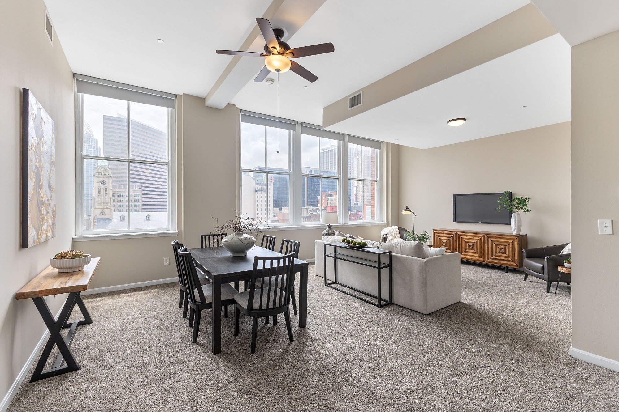 A living room with a dining table and chairs.