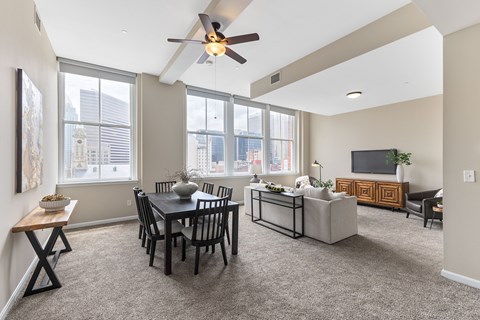 A living room with a dining table and chairs.