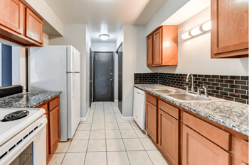 a kitchen with wooden cabinets and white appliances - Photo Gallery 19