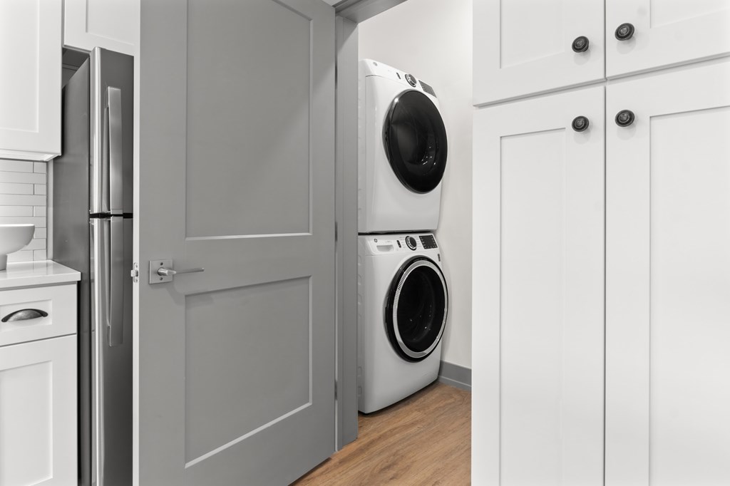 A white washing machine is in a kitchen. at The Ridge Apartments, Cincinnati, Ohio