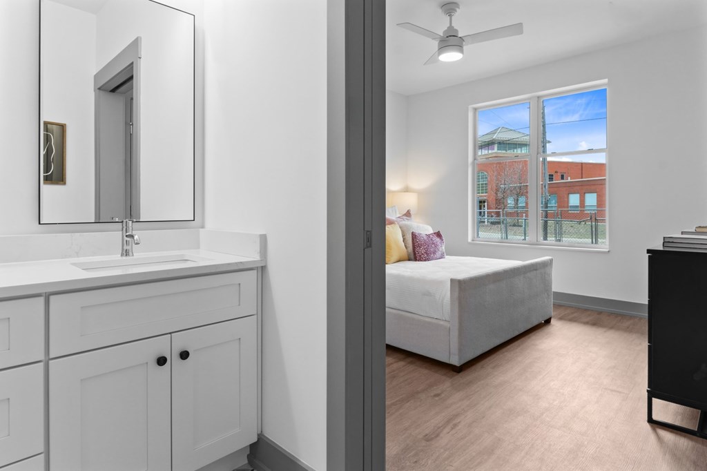 A bathroom with a white sink and a large mirror. at The Ridge Apartments, Ohio, 45213
