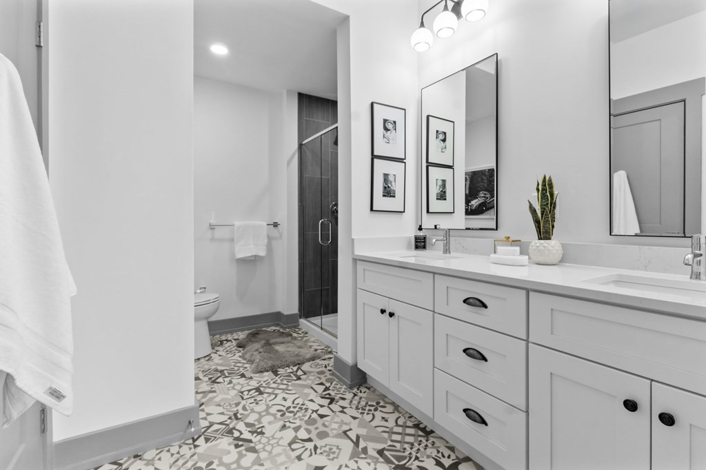 A bathroom with a white towel hanging on the door. at The Ridge Apartments, Cincinnati, OH