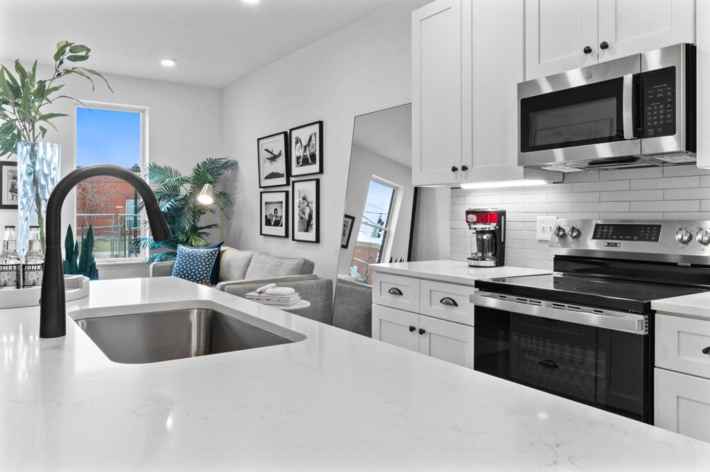 A modern kitchen with a large island and stainless steel appliances. at The Ridge Apartments, Cincinnati