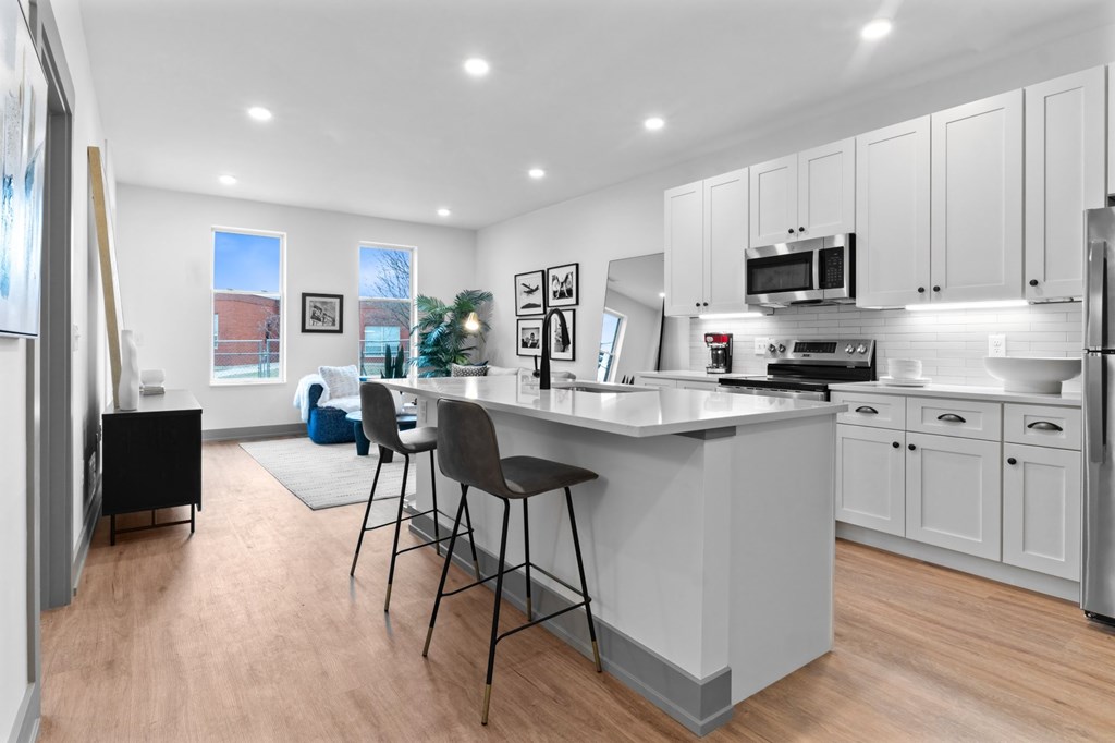 A kitchen with a white countertop and grey cabinets. at The Ridge Apartments, Cincinnati, OH