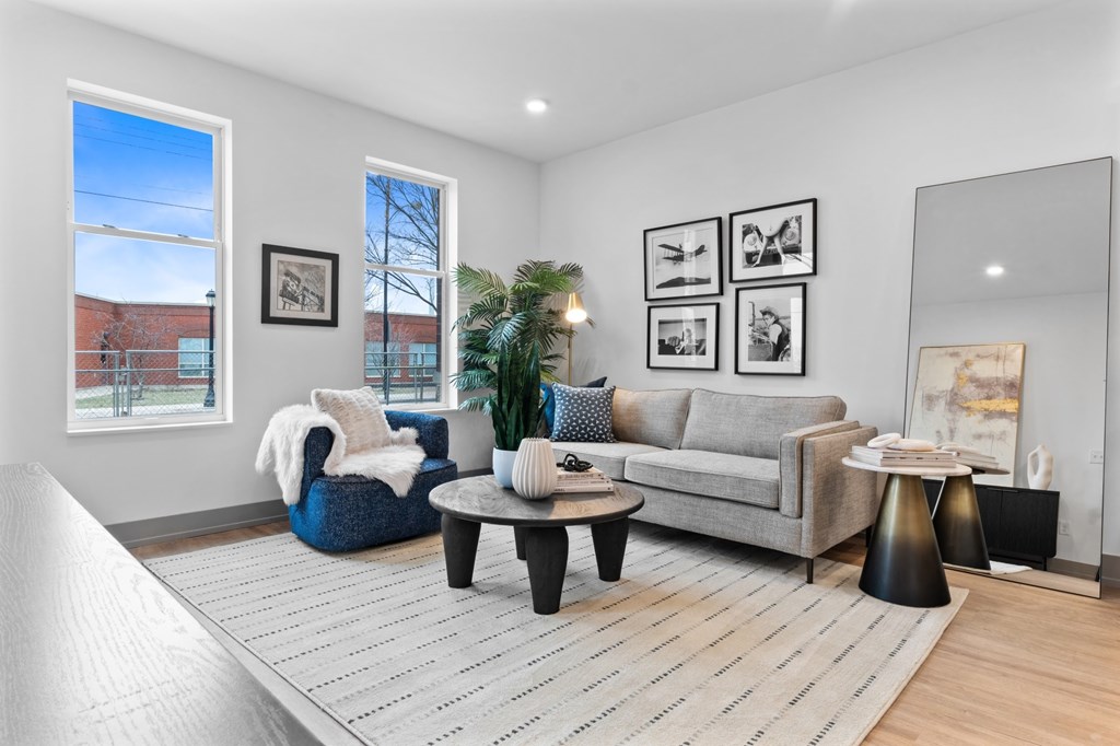 A living room with a grey couch, a blue chair, and a coffee table. at The Ridge Apartments, Cincinnati, OH