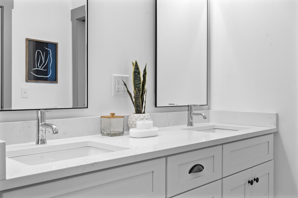 A bathroom with a white sink and a mirror. at The Ridge Apartments, Cincinnati