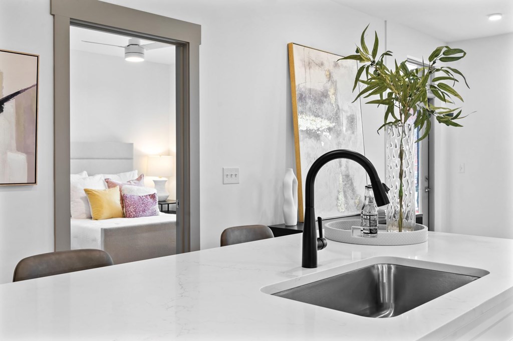 A modern kitchen with a white countertop and a black faucet. at The Ridge Apartments, Cincinnati, OH, 45213