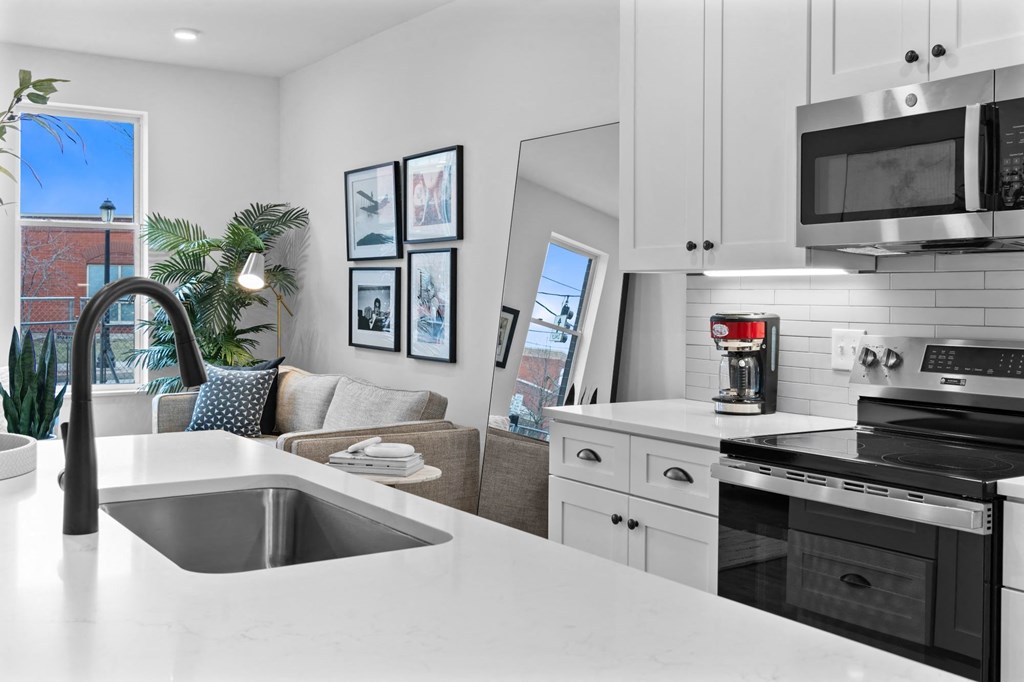 A modern kitchen with a stainless steel oven and microwave. at The Ridge Apartments, Cincinnati, OH