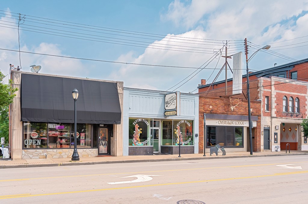 A street view of a small town with a variety of shops. at The Ridge Apartments, Ohio, 45213