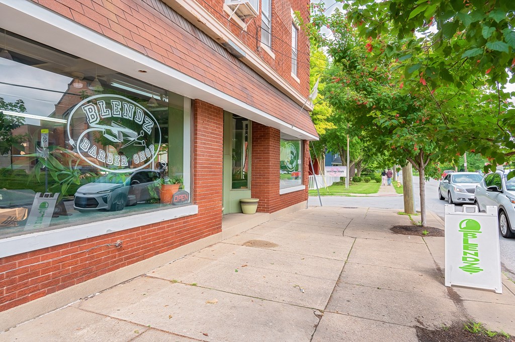 A storefront with a green sign at The Ridge Apartments, Ohio, 45213