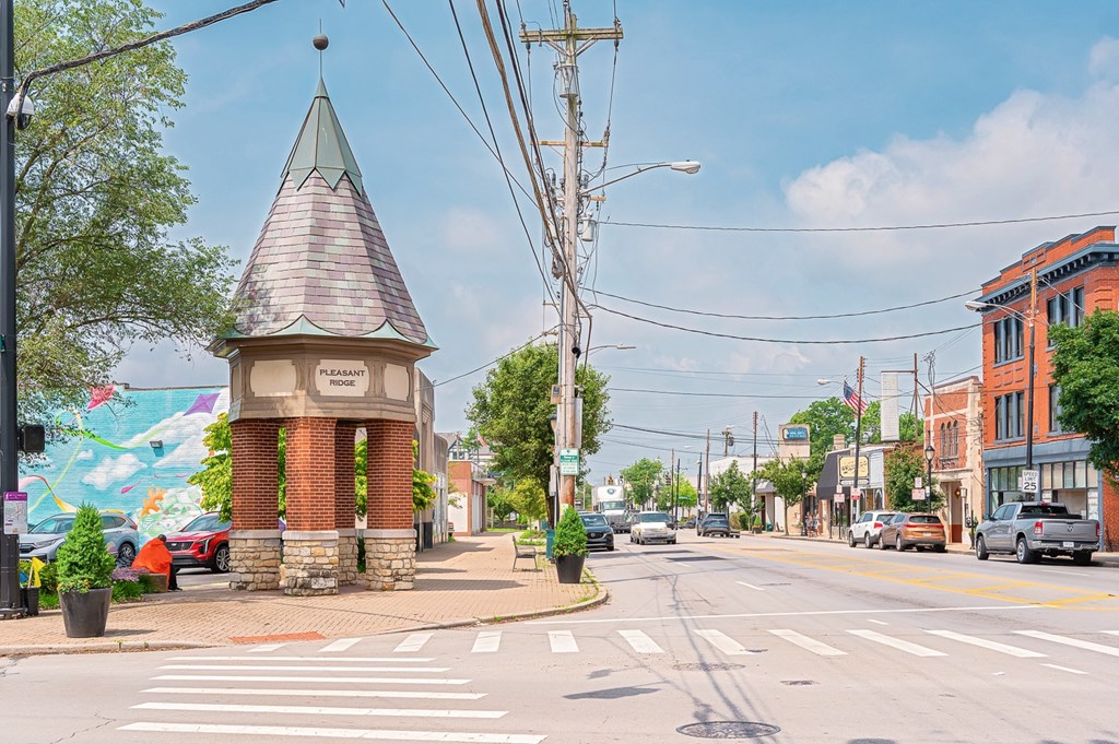A small brick tower with a green roof stands in the middle of a street. at The Ridge Apartments, Cincinnati, OH
