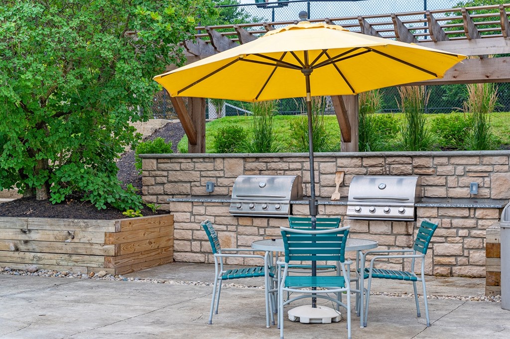 a patio with a table and chairs under an umbrella