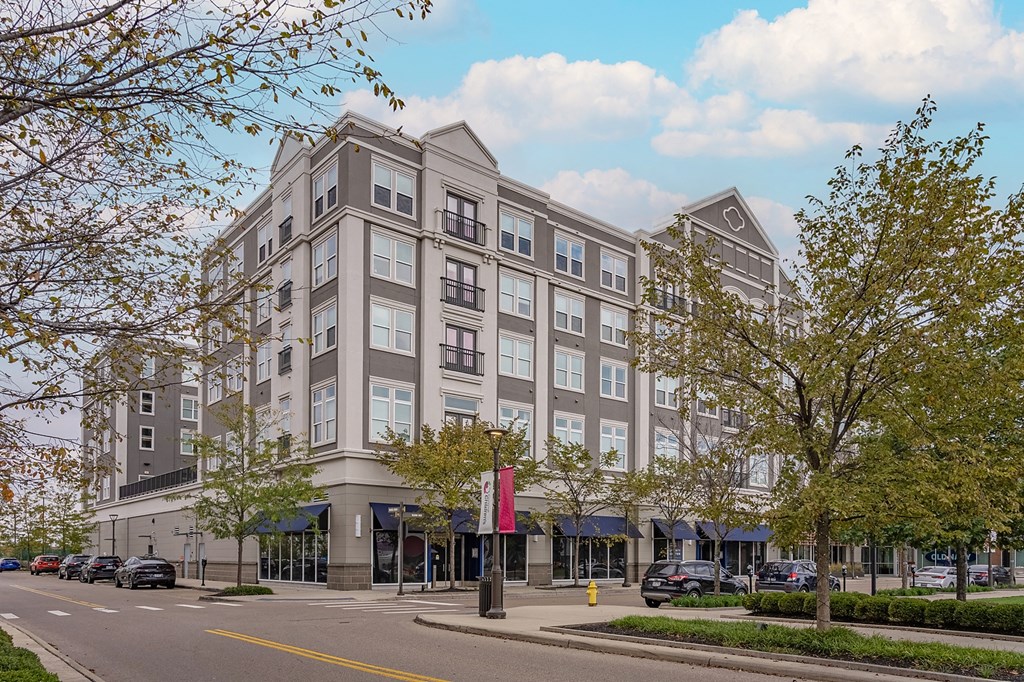 a large building on a city street with cars parked in front of it