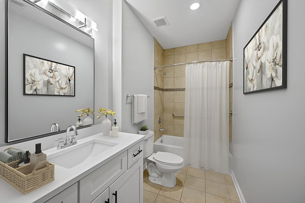 a bathroom with a sink toilet and a shower at Monmouth Row Apartments, Newport, KY