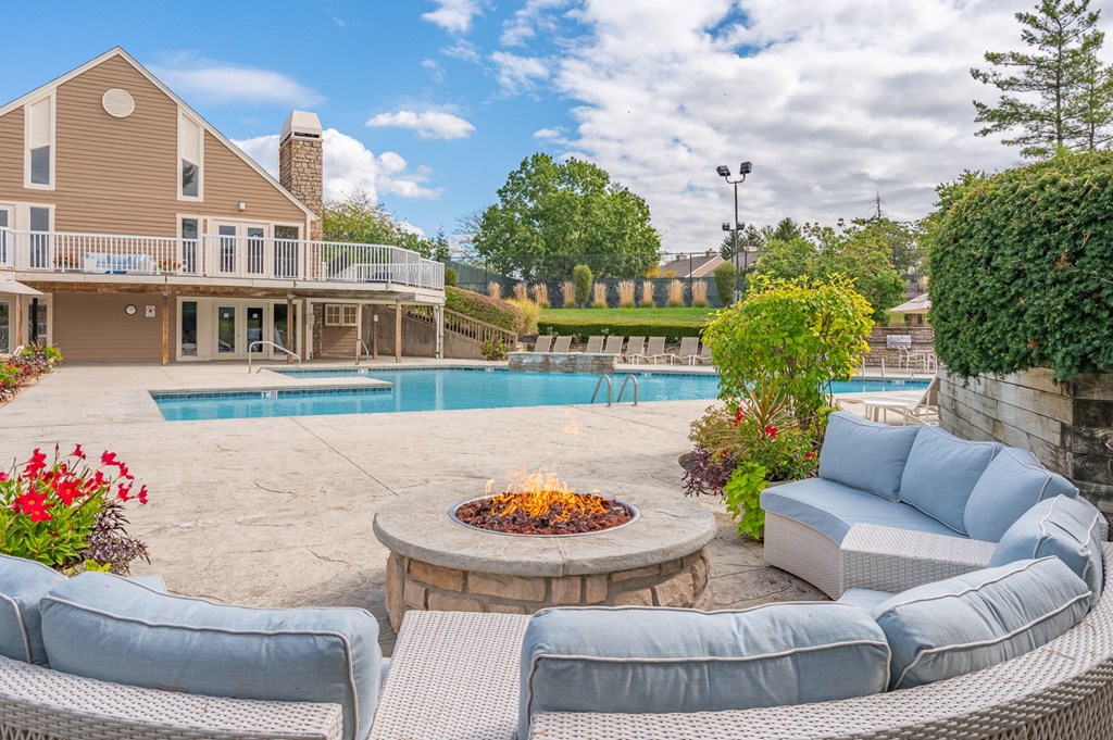 A house with a pool and a fire pit in the backyard.